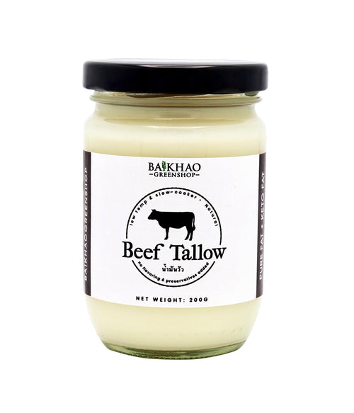 A glass jar of Baikhao Greenhouse Beef Tallow with a black lid and a white label featuring a black cow logo, set against a plain white background.